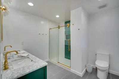 a bathroom with a shower and a sink and a toilet at Tree-Lined Lake Arrowhead Cabin about 1 Mi to Village! in Lake Arrowhead
