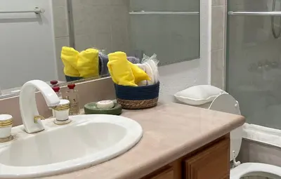 a bathroom with a sink and a toilet and a mirror at Ploy in Monterey Park