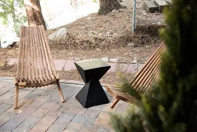 two chairs and a table on a patio at Modern Designer Cabin, Newly Renovated, EV Charger, Arcade, Kids Bunkbed, Minutes to Lake Arrowhead and Lake Gregory in Twin Peaks