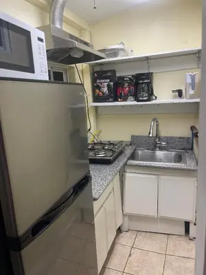 a small kitchen with a sink and a refrigerator at cozy & Quiet Tow Bed & one bath in Rosemead