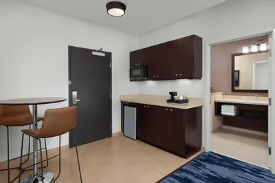 a kitchen with a table and a counter top at Fairfield Inn & Suites Riverside Corona/Norco in Norco