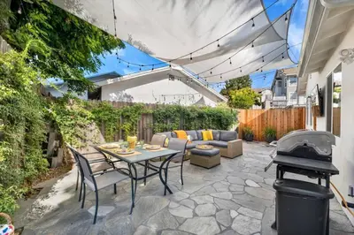 a patio with a table and chairs and a grill at Modern Cottage, Hot Tub, Bistro Patio, Putting Green, Walk to All! in Thousand Oaks