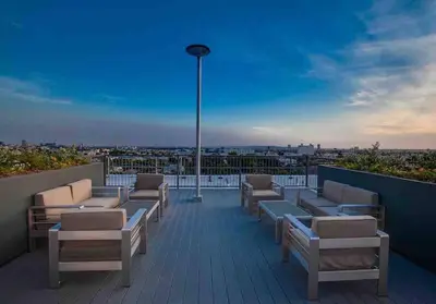 a balcony with chairs and a view of a city at Luxe Corner Penthouse 1BR Condo on Sunset in Los Angeles