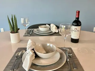 a table with a bowl and a bottle of wine at Luxe Corner Penthouse 1BR Condo on Sunset in Los Angeles