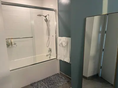 a bathroom with a shower with a glass door at Luxe Corner Penthouse 1BR Condo on Sunset in Los Angeles