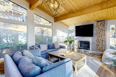 a living room with blue couches and a fireplace at Ferndale woods in Running Springs