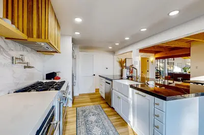 a kitchen with white cabinets and a stove top oven at Ferndale woods in Running Springs