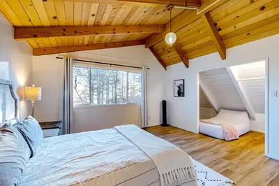 a bedroom with a large bed and a window at Ferndale woods in Running Springs