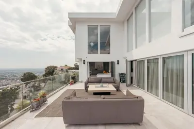 a house with a balcony with a couch at Exclusive Hillside Hideaway-Private Room in Los Angeles