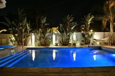 a swimming pool at night with plants and lights at Cali Luxury Dream Hideaway in Woodland Hills
