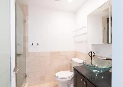 a bathroom with a toilet and a glass bowl on a counter at Cali Luxury Dream Hideaway in Woodland Hills
