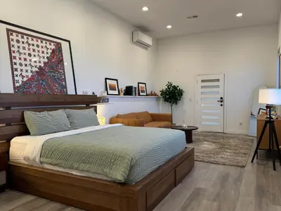 a bedroom with a large bed and a couch at Stunning View Hollywood Hills Guest House in Los Angeles
