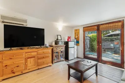 a living room with a large flat screen tv at Private Studio City Guest House in Los Angeles