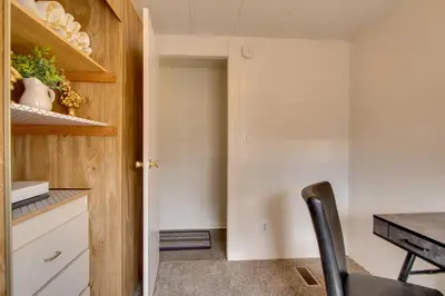 a kitchen with a table and a black chair at Rosamond Vacation Rental with Grill, Near Vineyards! in Rosamond