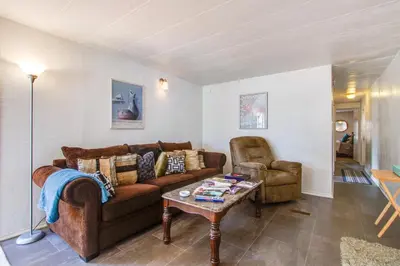 a living room with a couch and a table at Rosamond Vacation Rental with Grill, Near Vineyards! in Rosamond
