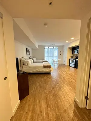 a large bedroom with a bed and a wooden floor at Studios Universal 10 min drive FREE parking and WIFI in Los Angeles