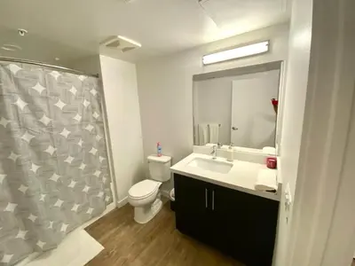a bathroom with a toilet and a sink and a mirror at Studios Universal 10 min drive FREE parking and WIFI in Los Angeles