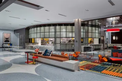 a lobby with a couch and chairs in a building at Hilton Buena Park Anaheim in Buena Park
