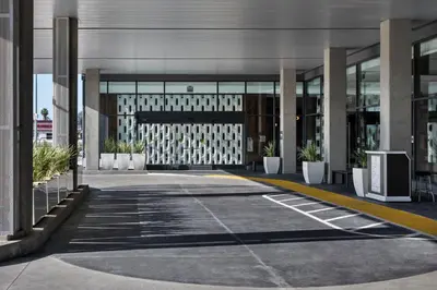an empty parking lot in front of a building at Hilton Buena Park Anaheim in Buena Park