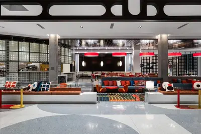 a lobby with couches and tables in a building at Hilton Buena Park Anaheim in Buena Park