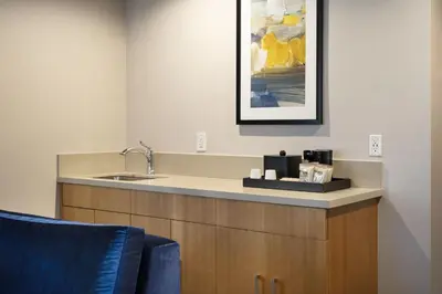 a bathroom with a sink and a picture on the wall at Courtyard by Marriott Los Angeles L.A. LIVE in Los Angeles