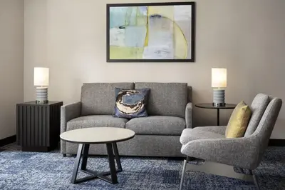 a living room with a couch and a chair and a table at Courtyard by Marriott Los Angeles L.A. LIVE in Los Angeles