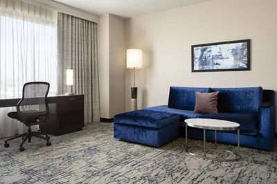 a living room with a blue couch and a chair at Residence Inn by Marriott Los Angeles L.A. LIVE in Los Angeles