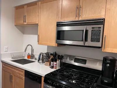 a kitchen with a stove and a microwave at Arion- Cozy Santa Monica getaway steps to the beach Free Parking in Los Angeles