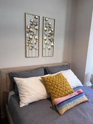 a bedroom with a bed with two pictures on the wall at Arion- Cozy Santa Monica getaway steps to the beach Free Parking in Los Angeles