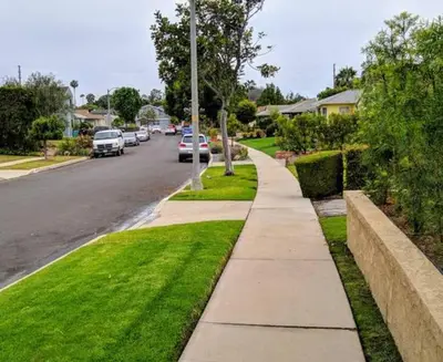 a sidewalk in a residential neighborhood with cars parked on the street at Monthly - Cozy 1 Bed Guest Suite near Venice Beach in Los Angeles