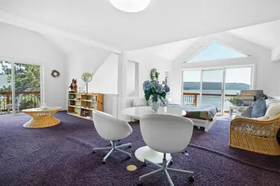 a white living room with a table and chairs at Amazing Grace - Zen mountain retreat with lake views in Fawnskin