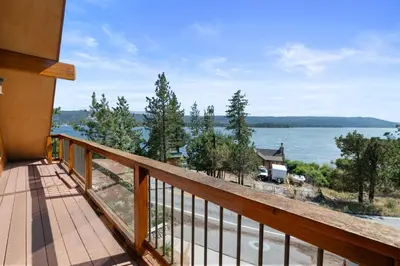 a balcony with a view of the water at Amazing Grace - Zen mountain retreat with lake views in Fawnskin