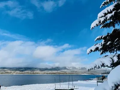 a view of a lake with snow on the ground at Clerestory Cottage - The perfect cozy getaway with a hot tub in Big Bear Lake