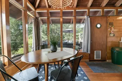 a dining room with a table and chairs at Clerestory Cottage - The perfect cozy getaway with a hot tub in Big Bear Lake