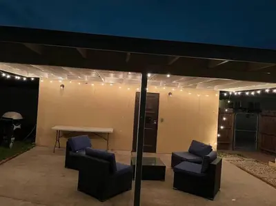 a patio with two chairs and a table and lights at Pool Table A C Grill Out Netflix Bikes Yard in Fullerton
