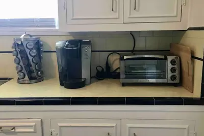 a microwave sitting on a counter in a kitchen at Pool Table A C Grill Out Netflix Bikes Yard in Fullerton