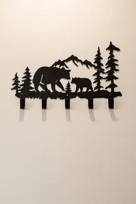 a black bear and two cubs on a wall with trees at California Inn in Anaheim