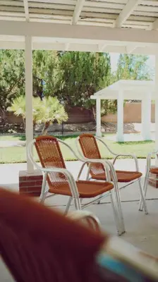 a group of chairs on a porch with a gazebo at Stylish & Bright ~ Huge Backyard ~ King Beds ~ Pkg in Palmdale