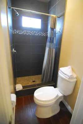 a bathroom with a toilet and a shower at Studio City Inn - Near Universal Studios Hollywood in Los Angeles