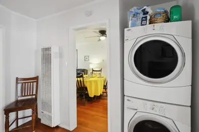 a kitchen with a washing machine and a dining room at Walk to Retro Row Long Beach Condo in Long Beach
