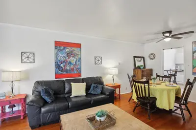a living room with a couch and a table at Walk to Retro Row Long Beach Condo in Long Beach