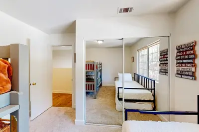 a room with a bed and a mirror at Lake Gregory Escape in Crestline