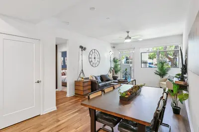 a living room with a table and a couch at Beverly Grove Chic City Oasis 2 BR Apt with Den 138 in Los Angeles