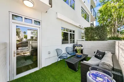 a patio with a couch and chairs on the grass at Beverly Grove Chic City Oasis 2 BR Apt with Den 138 in Los Angeles