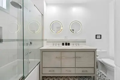a bathroom with a sink and a shower and mirrors at Universal Studios Villa with Pool & Guesthouse in Los Angeles