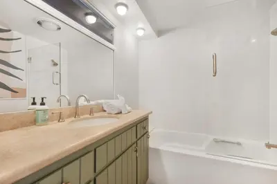 a bathroom with a sink and a tub and a mirror at Beverly Tree House in Los Angeles