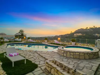 a swimming pool with a chair and a table at Beverly Tree House in Los Angeles