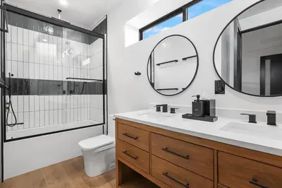 a bathroom with a sink and a mirror at NEW Luxury Concrete Home Just Minutes from the Beach in Long Beach