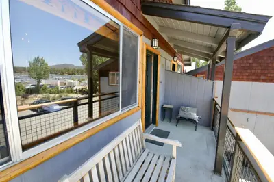 a porch of a house with a bench and a window at Lakefront Escape in Big Bear Lake