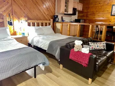a bedroom with a bed and a couch with two teddy bears at Lakefront Escape in Big Bear Lake